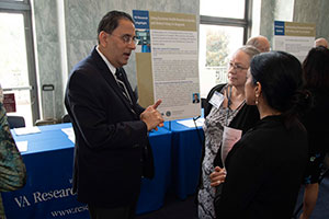 Hardeep Singh, MD, MPH, (L) discussing his work on patient safety at VA Research Day on the Hill.