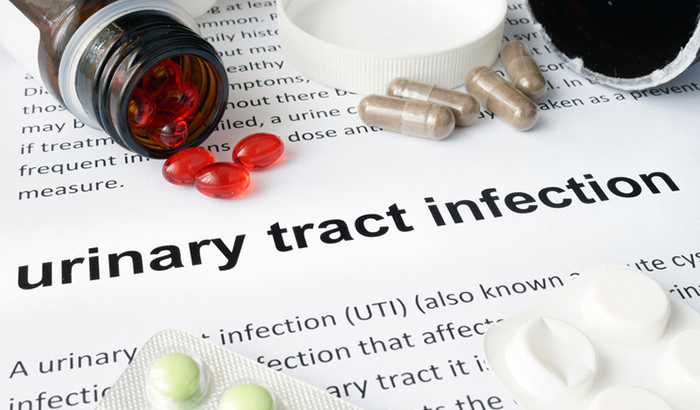 Paper with urinary tract infection  and pills. Medical concept.